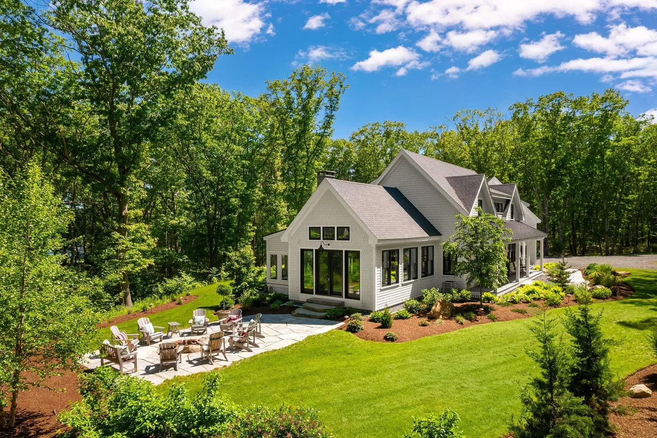 Aerial view of the house, lawn, and stone patio